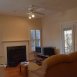 Family room has a fireplace, a ceiling fan & access to the screen porch.