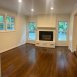 Den with electric fireplace off living room